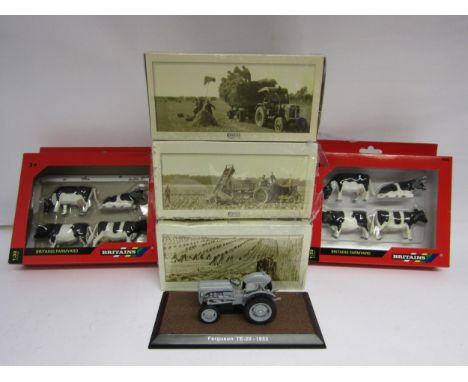 Three boxed Atlas Editions model tractors (boxes worn) together with two boxed sets of Britains plastic Friesian cows (one op