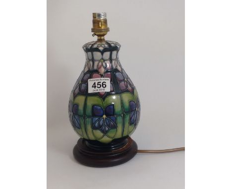 Moorcroft lamp base decorated with Art Nouveau floral design, height , on wood base (some wood missing)