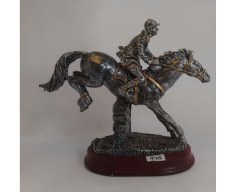 Resin silver model of male show jumper jumping a fence on wood base