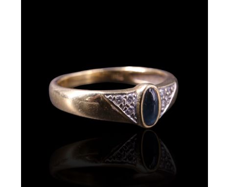 A blue stone cabochon (tested as jadeite) and diamond ring, the elongated oval cabochon bezel-set between triangular fields o