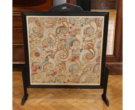 A late 19th / early 20th Century ebonised fire screen with embroidered insert, 75 x 97 cm