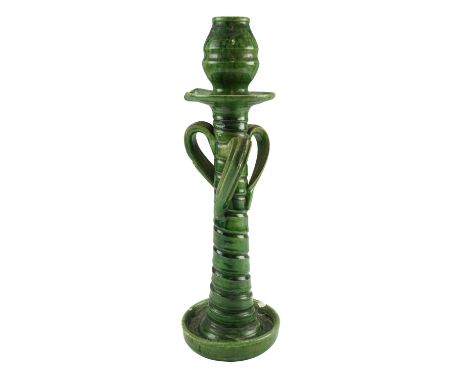 A late 19th / early 20th Century Arts and Crafts green-glazed earthenware candlestick, (a/f), 39 cm