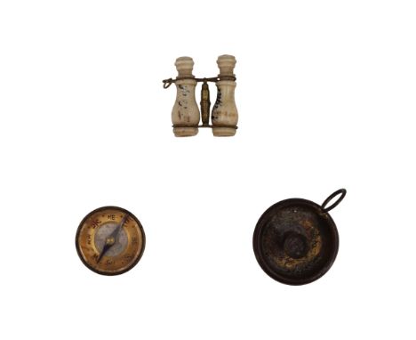 A Stanhope viewer in the form of a pair of binoculars, together with a miniature magnetic compass and a chamber stick 