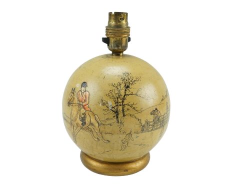A turned and painted wooden table lamp, of spherical form with gilt moulded foot, hand-decorated with a hunting scene, signed