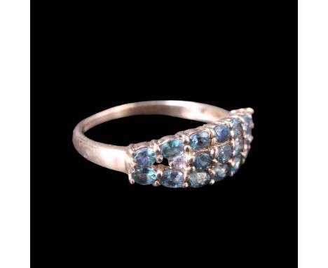 An alexandrite and white sapphire dress ring comprising a tonneau-shaped arrangement of oval and round-cut stones of approx 0