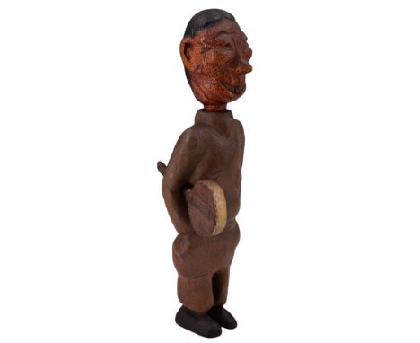 A carved and painted comical wooden nodding George Formby figure, modelled standing in an ENSA-style uniform with his signatu