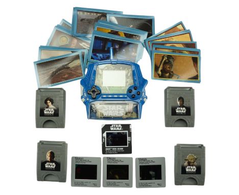 A 1999 Star Wars Episode I Battle of Naboo hand-held video game console by Tiger Electronics, together with a group of Merlin