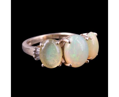 An opal and diamond finger ring comprising three graded oval opal cabochons, claw-set between radial arrangements of smaller 