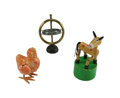 The Blondin Gyroscope with an instruction leaflet, 9 cm together with a wooden donkey with threaded movement and a cockerel 