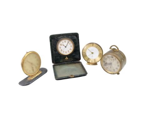 An early 20th Century Zenith Watch Co brass bedside alarm clock together with a travel timepiece and two vintage desk or beds