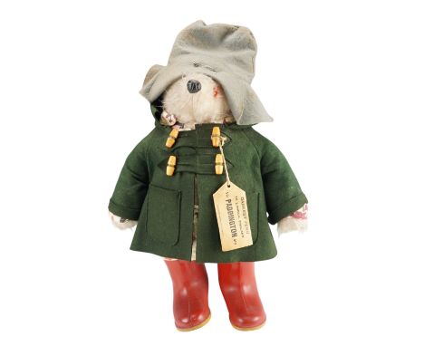 A Gabrielle Designs 1970s Paddington Bear with green felt duffel coat and red Dunlop wellingtons, design registration number 