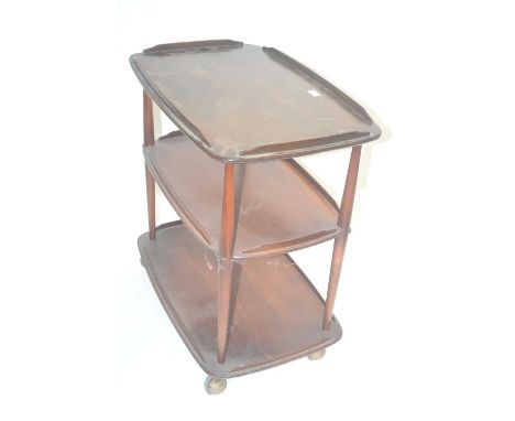 An Ercol dark elm three tier tea trolley on wheels, 70cm wide