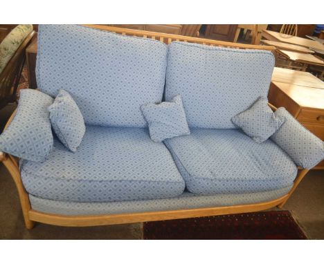 An Ercol light elm framed sofa with blue loose cushions, 190cm wide