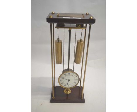 A contemporary Rising Works clock set in a brass and hardwood frame bearing plaque for Franklin Mint, 65cm high