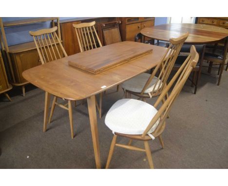 An Ercol light elm extending dining table with two additional leaves together with a set of four stick back chairsIn reasonab