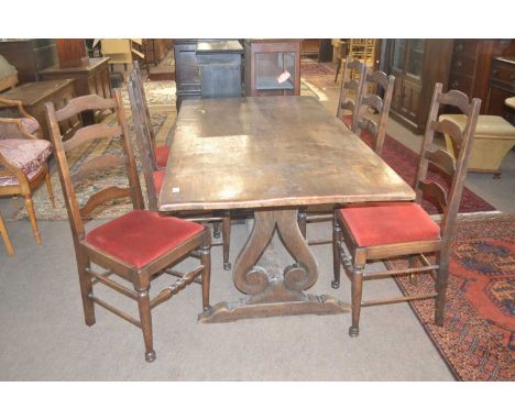 A 20th Century oak refectory style dining table with heavy plank top supported on two lyre shaped ends with central stretcher