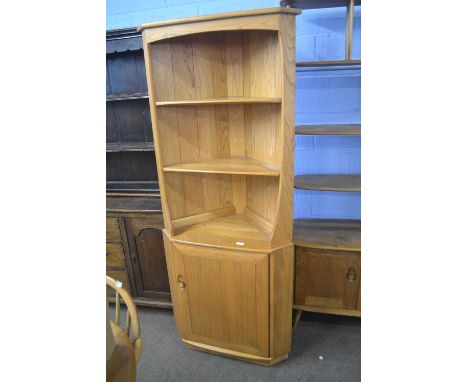 An Ercol light elm corner cabinet with open two shelf top section and a cupboard base, 178cm high