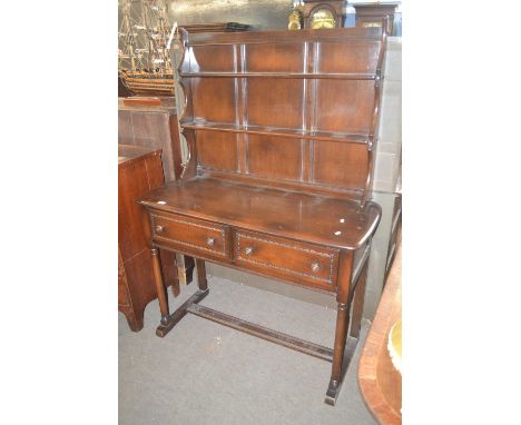 An Ercol dark elm dresser with two shelf back over a base with two drawers, turned legs and H formed stretchers, 113cm wide