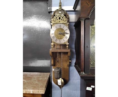 A brass lantern clock likely of Victorian manufacture, the clock of typical form with large hooded bell, pierced panelled dec