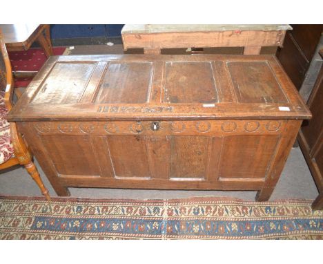 17th Century oak coffer of typical form, the four panel top opening to an interior with candle box, the four panelled front w