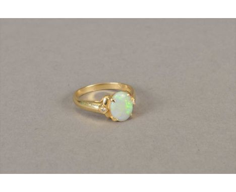 An opal and diamond ring, designed as a central oval opal flanked to each side by a brilliant cut diamond, the yellow metal s