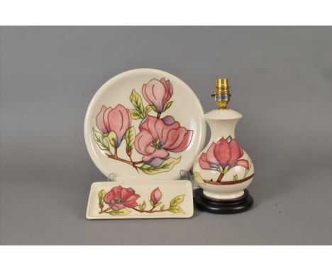 A Moorcroft pottery lamp base (20 th /21 st century), of baluster form, tube lined with pink magnolia against overall cream g