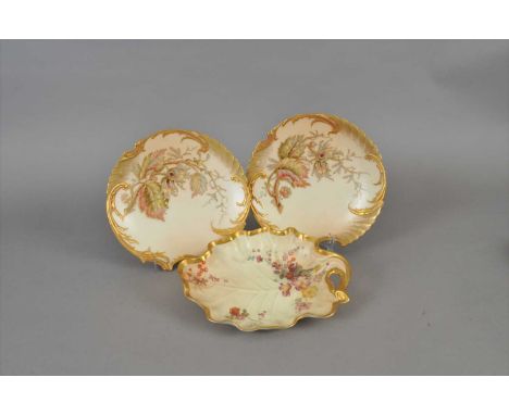 A set of four Royal Worcester dessert plates, late 19th century, of Rococo outline with gilt moulded rim, painted in colours 