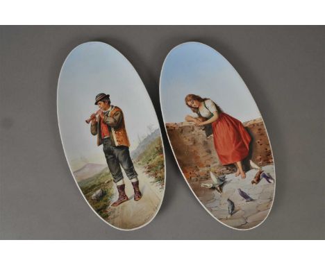 A pair of S. C. Richard (Milan, Italy) oval dishes, late 19th century painted with a male musician playing pipe and a young g