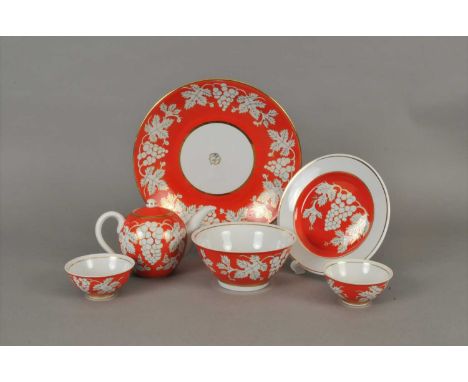 A Russian porcelain tea service decorated in bright orange with gilded leaves and grapes, comprising teapot and cover, five t