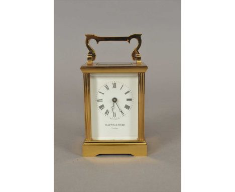 A Mappin &amp; Webb brass cased carriage clock, with black Roman numerals over a white dial, set within bevelled glass, flank