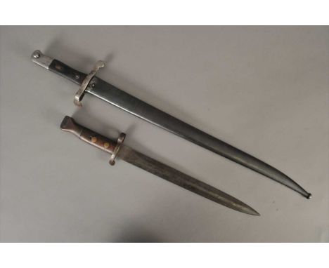 A Portuguese M1886 sword bayonet in scabbard, indistinctly dated 1886 to the back edge of the fullered yataghan blade, crossp