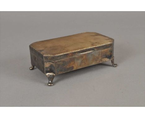 A silver trinket box, Walker &amp; Hall, Birmingham 1929, of rectangular form with canted corners and raised on four feet, 15