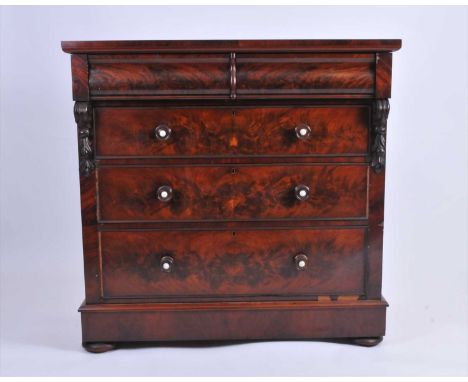 A large Victorian mahogany chest of drawers, the over-hanging plain top above a pair of short bombe drawers, over a further g