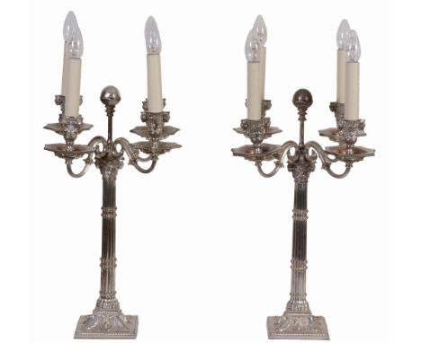 A set of four electroplated metal four-light candelabra, circa 1880 A set of four electroplated metal four-light candelabra, 