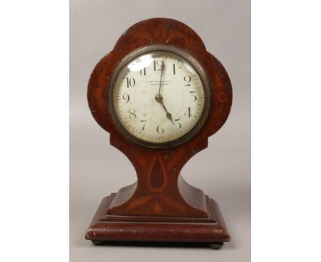 An Edwardian inlaid mahogany balloon mantel clock with cylinder movement and raised on ball feet. 