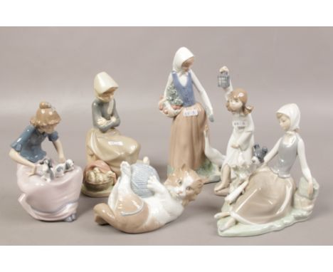 A collection of Nao figures to include lady with puppies, kitten with yarn, along with a Lladro example. 