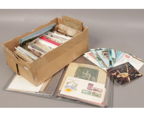 A shoe box and an album of colour and monochrome postcards. 