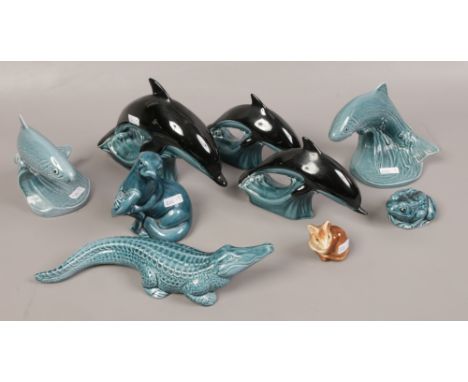 A collection of Poole pottery to include three dolphins, two trout, alligator, otter, frog and mouse. 