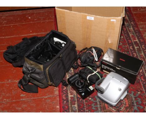 A collection of photographic equipment to include retro Polaroid P 600, Minolta Zoom 90, Nikon Coolpix in Lowpro case, Nikon 