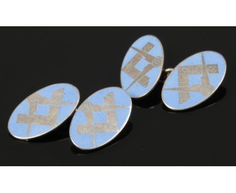 A pair of oval silver and enamel masonic cufflinks. 