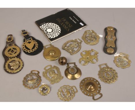 A collection of horse brasses, along with a George Hartfield Horse Brasses reference book, print 1965. 