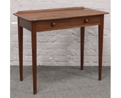 A mahogany two drawer side table raised on square  tapering legs. 