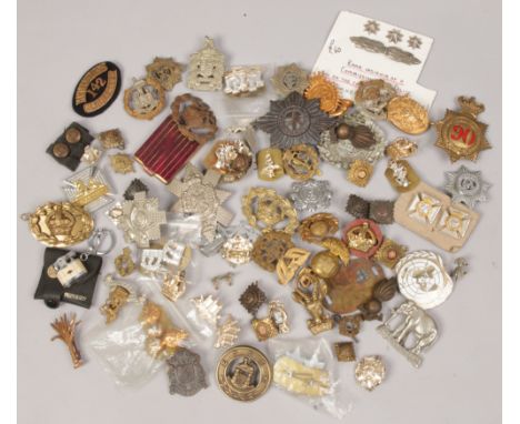 A box of military badges to include Red Cross Gloucestershire, engineers volunteers, Royal Kent West, Royal Army Service Corp