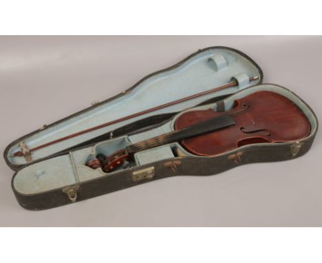 A German cased violin and bow with one piece back bearing label Antonius Stradivarius. 