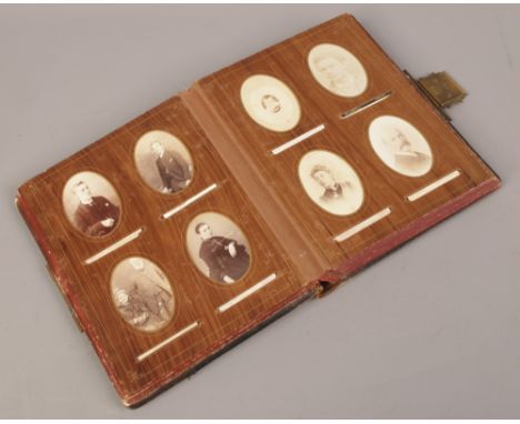 A Victorian photograph album with contents of portrait photographs. 