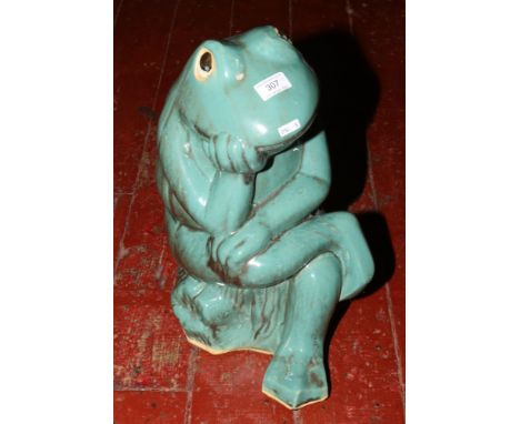 A ceramic green frog ornament. 