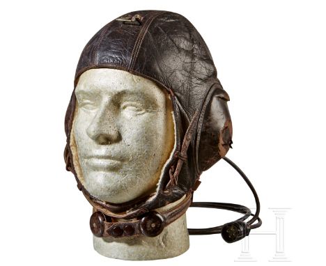 An "LKpW101" Winter Flight Helmet   Five panel brown leather construction, leather covered earphone mounts with a grooved lip