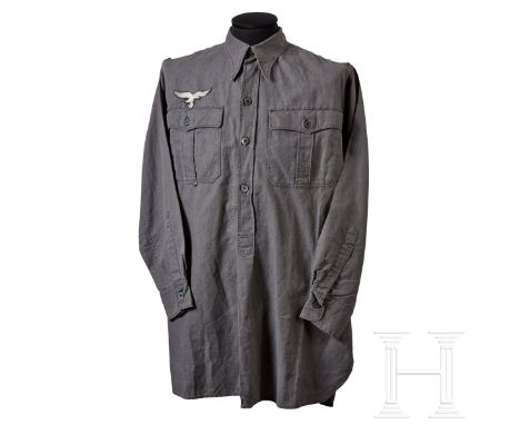 A Pullover Shirt  Blue-grey pullover fabric shirt, 1944 pattern. Long sleeve, four button front with buttoned collar closure,