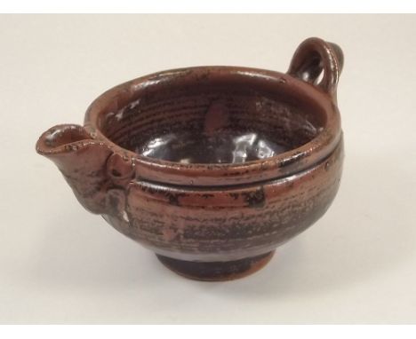 TREVOR CORSER.
A 1 pint sauce bowl with loop handle by Trevor Corser. Width 19cm. Impressed personal & Leach Pottery marks. 