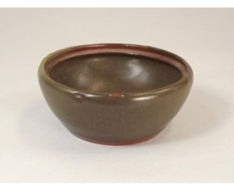 BERNARD LEACH.
A small bowl by Bernard Leach lacking a lid. Cross-hatched decoration on each side partially obscured by glaze